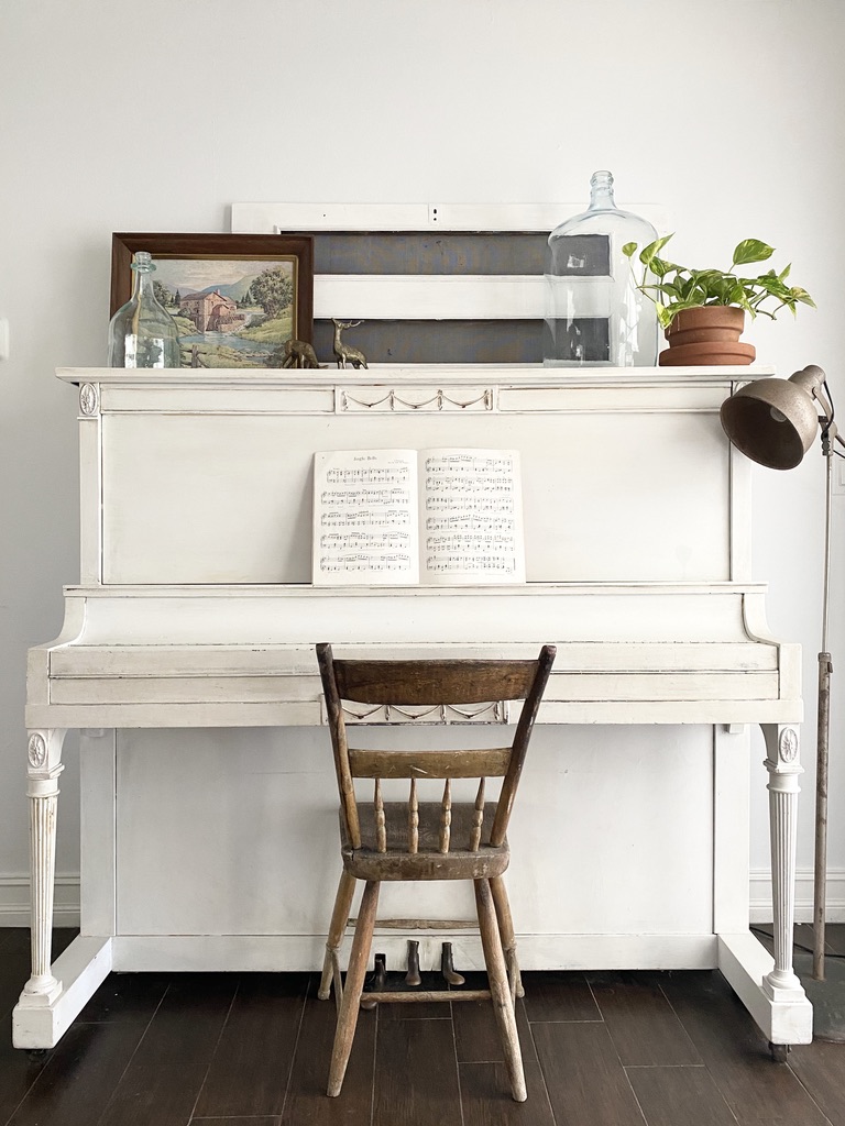 An antique painted piano styled with vintage summer inspired decor