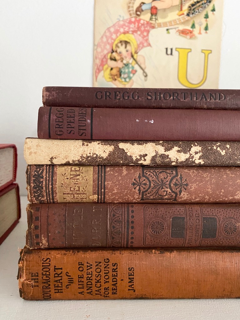 A stack of red and orange vintage books make great back to school decor