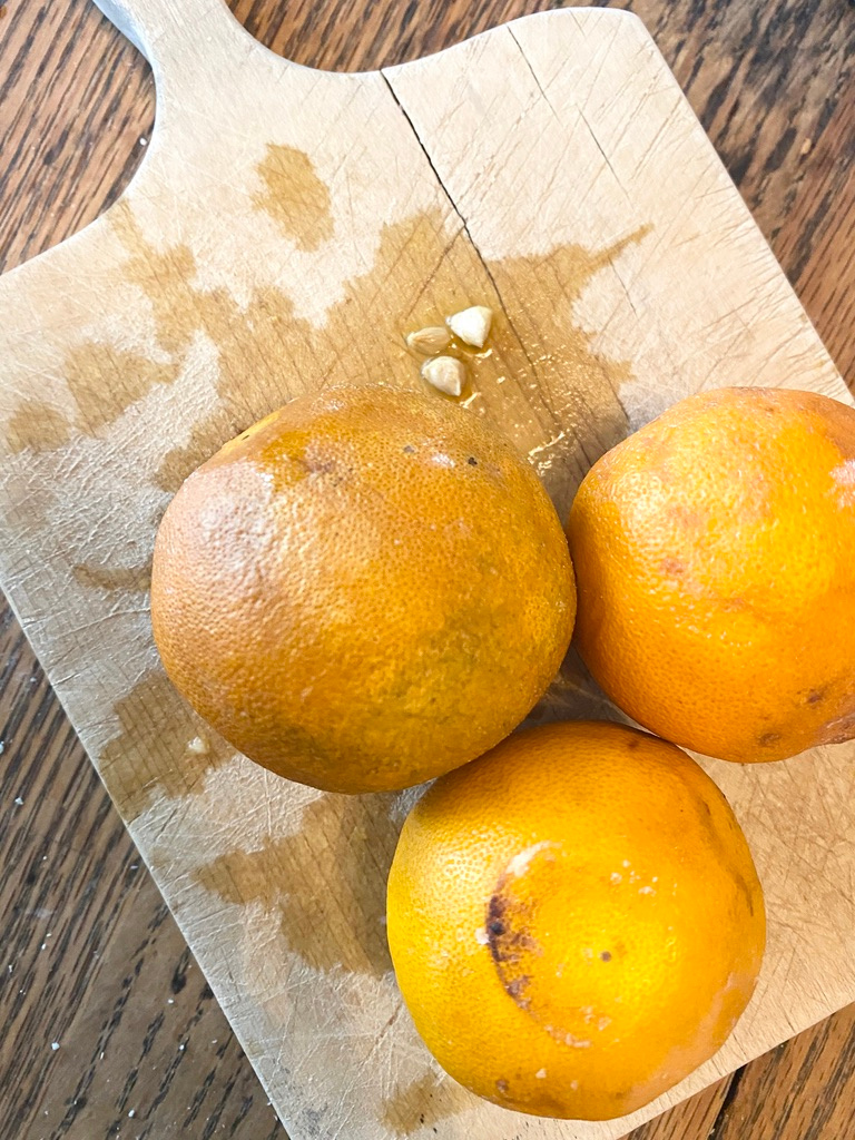 Oranges on a wooden cutting board