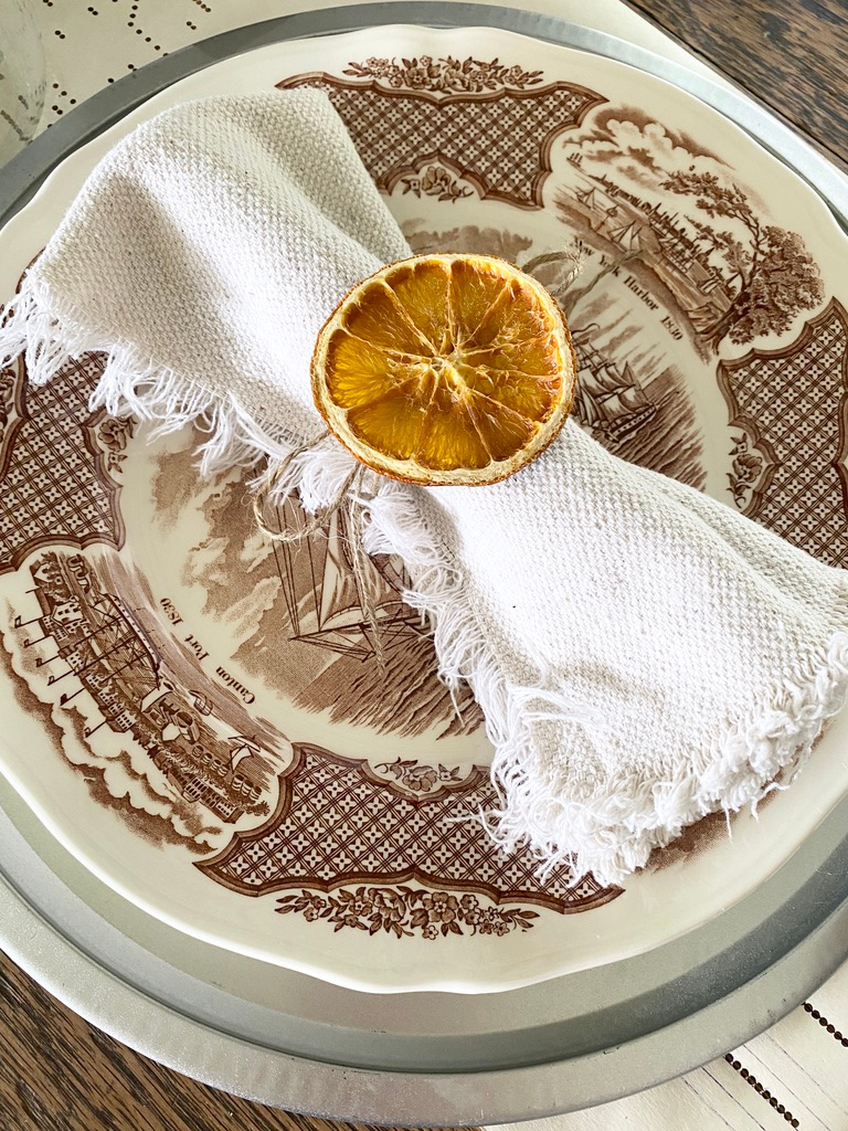 Drop cloth napkins with dried orange napkin rings