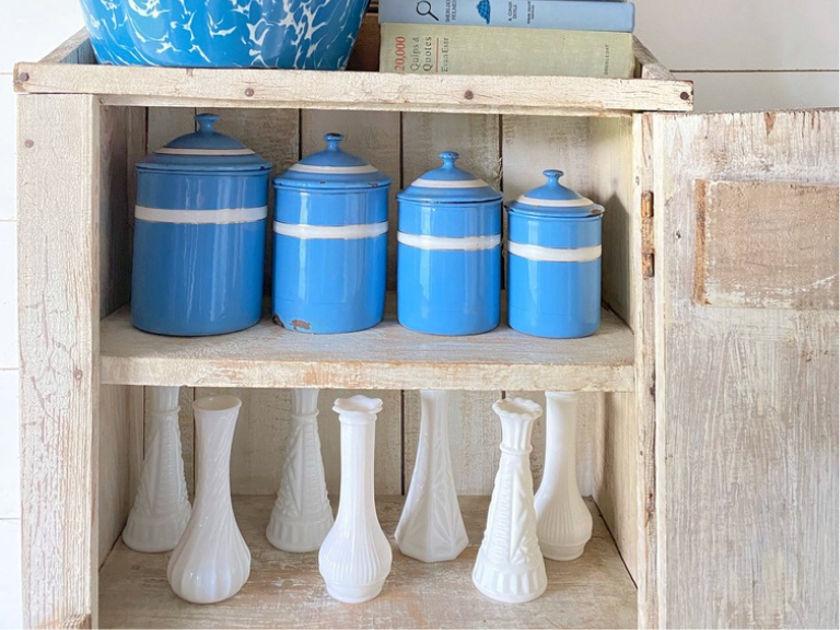 a collection of vintage milk glass vases and enamel canisters 